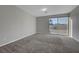 Bedroom features neutral carpet and a sliding glass door to the balcony, with natural lighting at 10142 Skye Saddle Ave, Las Vegas, NV 89166