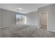 Bright bedroom with a sliding glass door to a balcony and neutral carpet at 10142 Skye Saddle Ave, Las Vegas, NV 89166