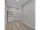 Bedroom with white shelving, wood-look flooring, and natural light coming in from another room at 10142 Skye Saddle Ave, Las Vegas, NV 89166