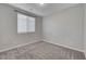 Neutral bedroom with carpet, base molding, window with blinds, and standard ceiling light at 10142 Skye Saddle Ave, Las Vegas, NV 89166