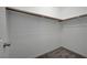 A simple walk-in closet with shelving and neutral carpeting for tidy storage at 10142 Skye Saddle Ave, Las Vegas, NV 89166