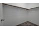 A simple walk-in closet with shelving and neutral carpeting for tidy storage at 10142 Skye Saddle Ave, Las Vegas, NV 89166