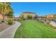 Well-manicured community park with green grass, mature trees, walking path and pergola at 10142 Skye Saddle Ave, Las Vegas, NV 89166