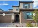 Charming two-story home with a stone facade and a well-manicured front yard at 10142 Skye Saddle Ave, Las Vegas, NV 89166