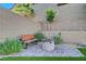Stone fire pit with wooden bench in a cozy backyard setting at 10142 Skye Saddle Ave, Las Vegas, NV 89166