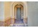 Close up of front door with brick trim and an arched entry way at 10142 Skye Saddle Ave, Las Vegas, NV 89166