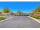 Grand gated entrance with stone pillars and lush landscaping creates a secure community at 10142 Skye Saddle Ave, Las Vegas, NV 89166