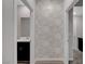 Hallway with decorative wall paper leading to a bathroom at 10142 Skye Saddle Ave, Las Vegas, NV 89166