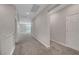 Hallway with neutral carpet leading to another room, and doors on either side at 10142 Skye Saddle Ave, Las Vegas, NV 89166