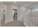 Hallway leading to an upstairs laundry room with carpet flooring and bright lighting at 10142 Skye Saddle Ave, Las Vegas, NV 89166