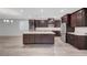 Modern kitchen with stainless steel appliances, dark cabinetry, and a large center island at 10142 Skye Saddle Ave, Las Vegas, NV 89166