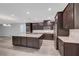 Open kitchen showcasing stainless steel appliances and a spacious island with granite countertops at 10142 Skye Saddle Ave, Las Vegas, NV 89166