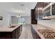 Open kitchen featuring granite countertops, stainless steel appliances and dark wood cabinets at 10142 Skye Saddle Ave, Las Vegas, NV 89166