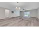 Light-filled living room featuring hard floors, modern chandelier, and access to the backyard at 10142 Skye Saddle Ave, Las Vegas, NV 89166