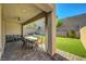 Covered patio with ceiling fan, furniture, and dining set overlooking the lovely backyard at 10142 Skye Saddle Ave, Las Vegas, NV 89166