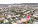 Expansive aerial view of a residential neighborhood with community park, pools and mountain views at 10392 Smokemont Ct, Las Vegas, NV 89129