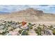 Aerial view of home surrounded by neighborhood and mountain range in the background at 10392 Smokemont Ct, Las Vegas, NV 89129