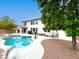 Private backyard featuring a sparkling pool, covered patio, and lush landscaping at 10392 Smokemont Ct, Las Vegas, NV 89129