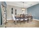 Elegant dining room with a modern chandelier, ample seating, and stylish decor at 10392 Smokemont Ct, Las Vegas, NV 89129