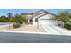 Charming two-story home with a two car garage, rock yard, and manicured shrubs at 10392 Smokemont Ct, Las Vegas, NV 89129