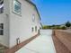 Side view of a two-story house showcasing a concrete driveway and access gate at 10392 Smokemont Ct, Las Vegas, NV 89129
