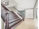 Inviting foyer with staircase, tile flooring, and double door entrance at 10392 Smokemont Ct, Las Vegas, NV 89129