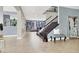 Open foyer featuring tile floors, staircase, and tasteful decor, creating a welcoming entrance at 10392 Smokemont Ct, Las Vegas, NV 89129