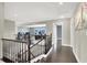 Bright hallway with dark wood floors, stylish railing and view into the office at 10392 Smokemont Ct, Las Vegas, NV 89129