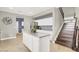 Open concept kitchen with island, granite counters, stainless appliances, and staircase access at 10392 Smokemont Ct, Las Vegas, NV 89129