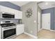 Updated kitchen with stainless steel appliances, granite countertops and white cabinetry at 10392 Smokemont Ct, Las Vegas, NV 89129