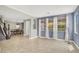 Open-concept living room with large windows, tile floors, and a view into the dining area at 10392 Smokemont Ct, Las Vegas, NV 89129