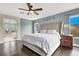 Spacious main bedroom features stylish decor, including an upholstered headboard and picturesque windows at 10392 Smokemont Ct, Las Vegas, NV 89129