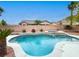 Beautiful backyard pool and spa with decorative stone accents and mature landscaping at 10392 Smokemont Ct, Las Vegas, NV 89129