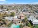 An aerial view of a home featuring a backyard pool, patio and the city skyline beyond at 107 Elm St, Henderson, NV 89015