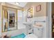 Bathroom featuring white tile, a sink, and a shower-tub combo with sliding glass doors at 107 Elm St, Henderson, NV 89015