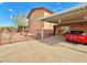 The home's exterior featuring a covered driveway and desert landscaped yard at 107 Elm St, Henderson, NV 89015