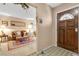Welcoming foyer featuring a decorative front door and an entry into the adjacent living room at 107 Elm St, Henderson, NV 89015