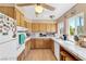 Well-lit kitchen with white appliances, wood cabinets, tile countertops, and an eat-in area at 107 Elm St, Henderson, NV 89015