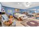 Cozy main bedroom with blue walls, carpet flooring, ceiling fan, and a large mirror at 107 Elm St, Henderson, NV 89015