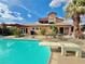 Inviting pool with diving board, patio, and lush landscaping, perfect for backyard relaxation at 107 Elm St, Henderson, NV 89015
