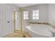 Bathroom showcasing a shower and a tub with decorative tile at 11009 Pentland Downs St, Las Vegas, NV 89141