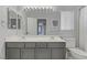 Bathroom features double sinks, gray vanity, and a window at 11009 Pentland Downs St, Las Vegas, NV 89141