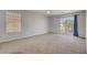 Carpeted bedroom with window and glass sliding doors accessing the balcony at 11009 Pentland Downs St, Las Vegas, NV 89141