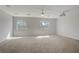 Spacious bonus room featuring plush carpeting, two windows, ceiling fan, and a mounted projector at 11009 Pentland Downs St, Las Vegas, NV 89141
