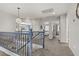 Upstairs hallway with grey carpet, blue banister, and star pendant lighting fixture at 11009 Pentland Downs St, Las Vegas, NV 89141
