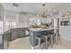 Modern kitchen featuring stainless steel appliances, marble countertops, and a stylish island with seating at 11009 Pentland Downs St, Las Vegas, NV 89141