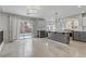 A spacious kitchen features a gray island, stainless steel appliances, and sliding glass doors to the pool at 11009 Pentland Downs St, Las Vegas, NV 89141