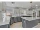 Modern kitchen with gray cabinetry, stainless steel appliances, and quartz countertops at 11009 Pentland Downs St, Las Vegas, NV 89141