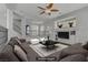 Bright living room featuring a ceiling fan, comfortable gray couch, and stylish decor at 11009 Pentland Downs St, Las Vegas, NV 89141