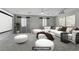 Cozy living room with white sofas, plush ottomans, and decorative throw pillows at 11009 Pentland Downs St, Las Vegas, NV 89141